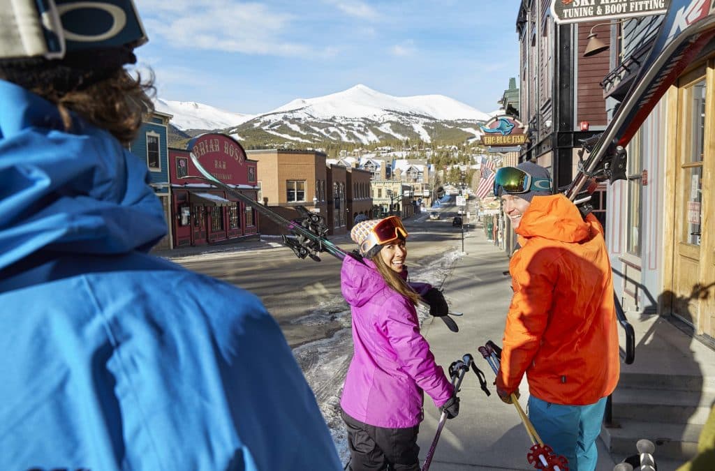 Two walkers with skis over their shoulders in Breckenridge