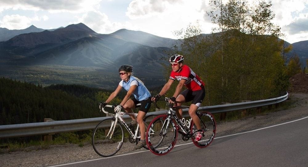 A couple road biking in Breckenridge.