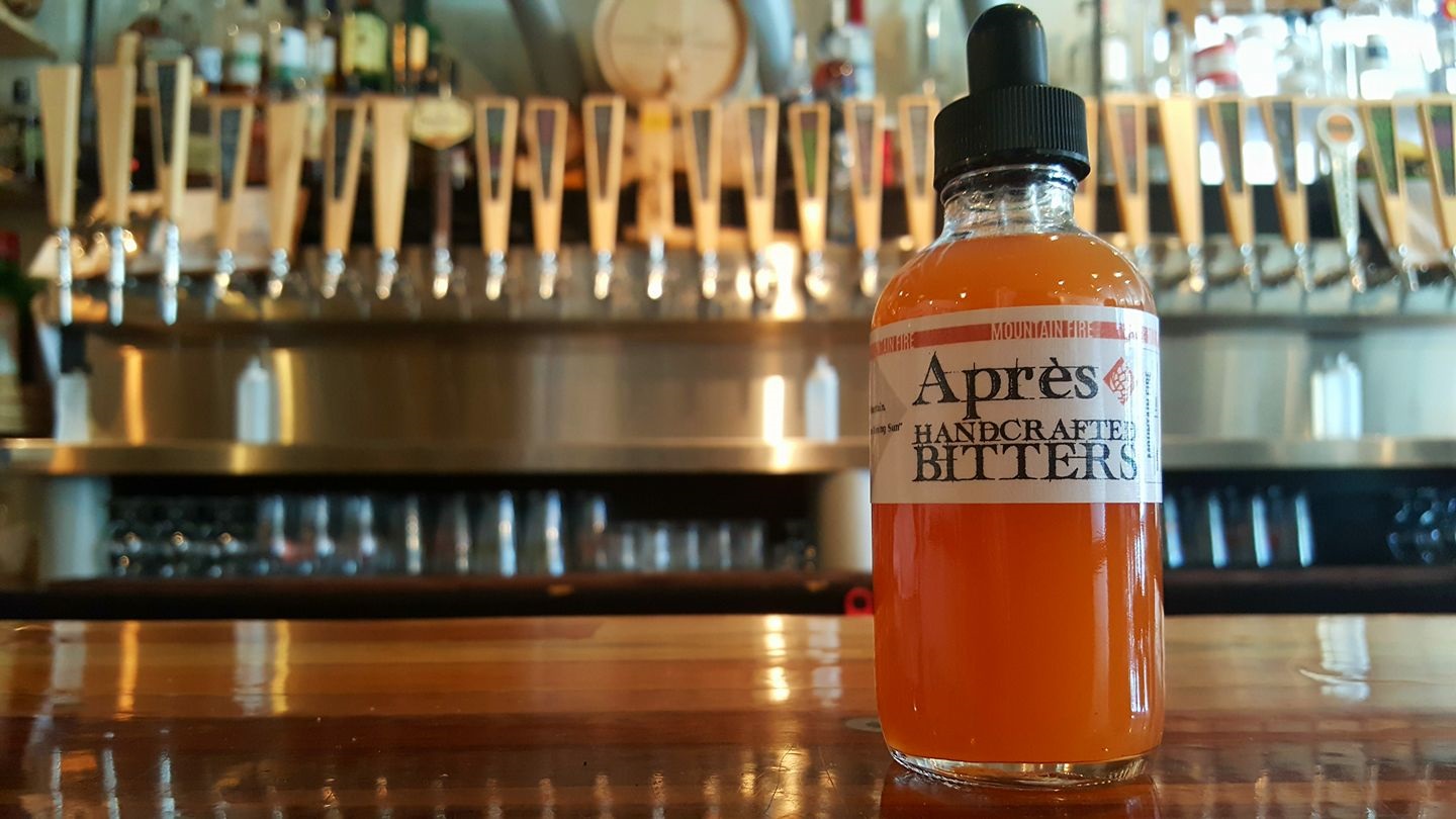 Bottle of bitters surrounded by beer taps at Après in Breckenridge, CO