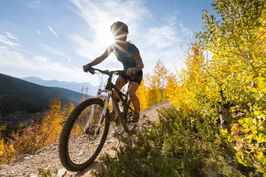 A Mountain Biker biking through Fall Trees in Breckenridge