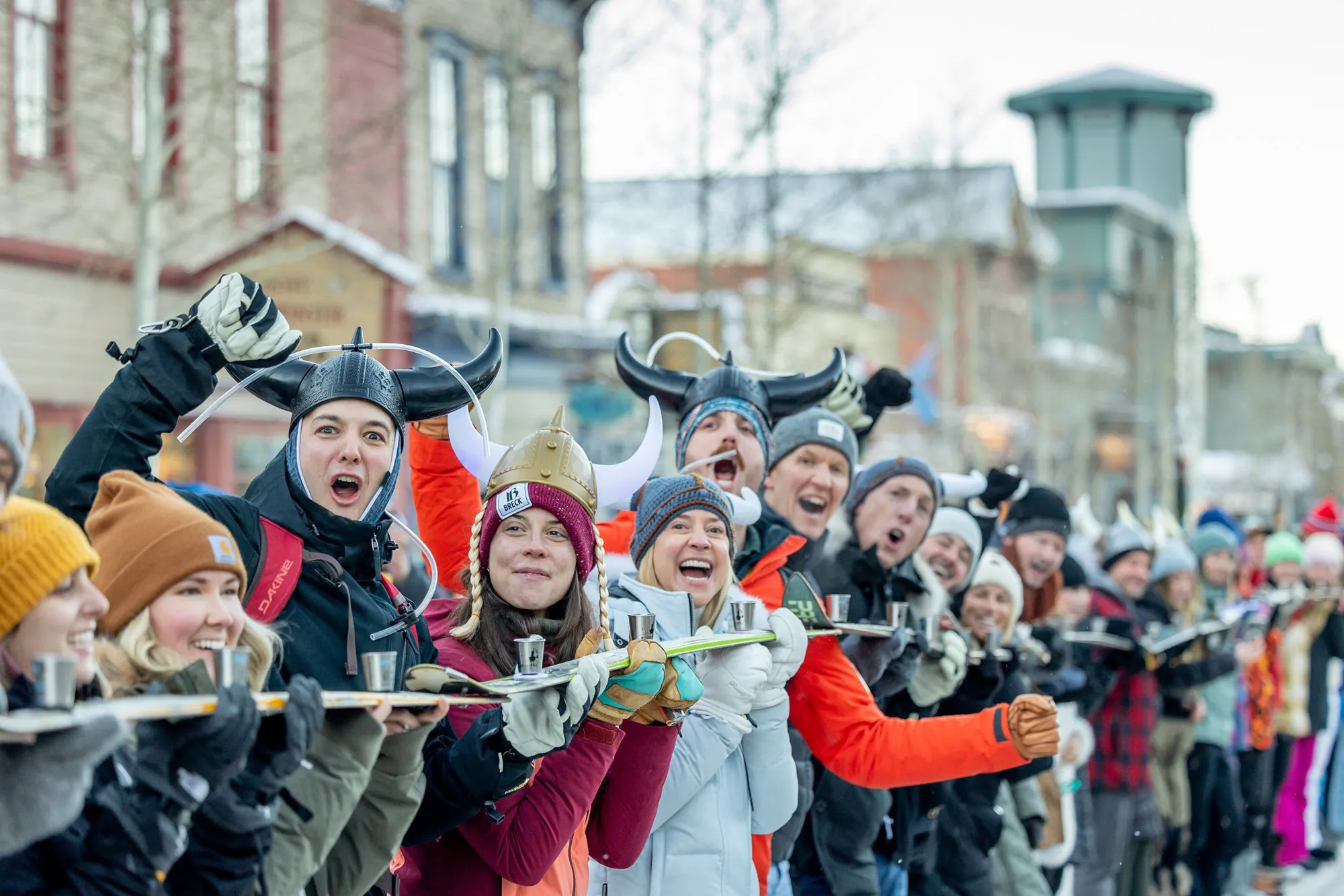 Participants raising a shared shotski during Ullr Fest in Breckenridge