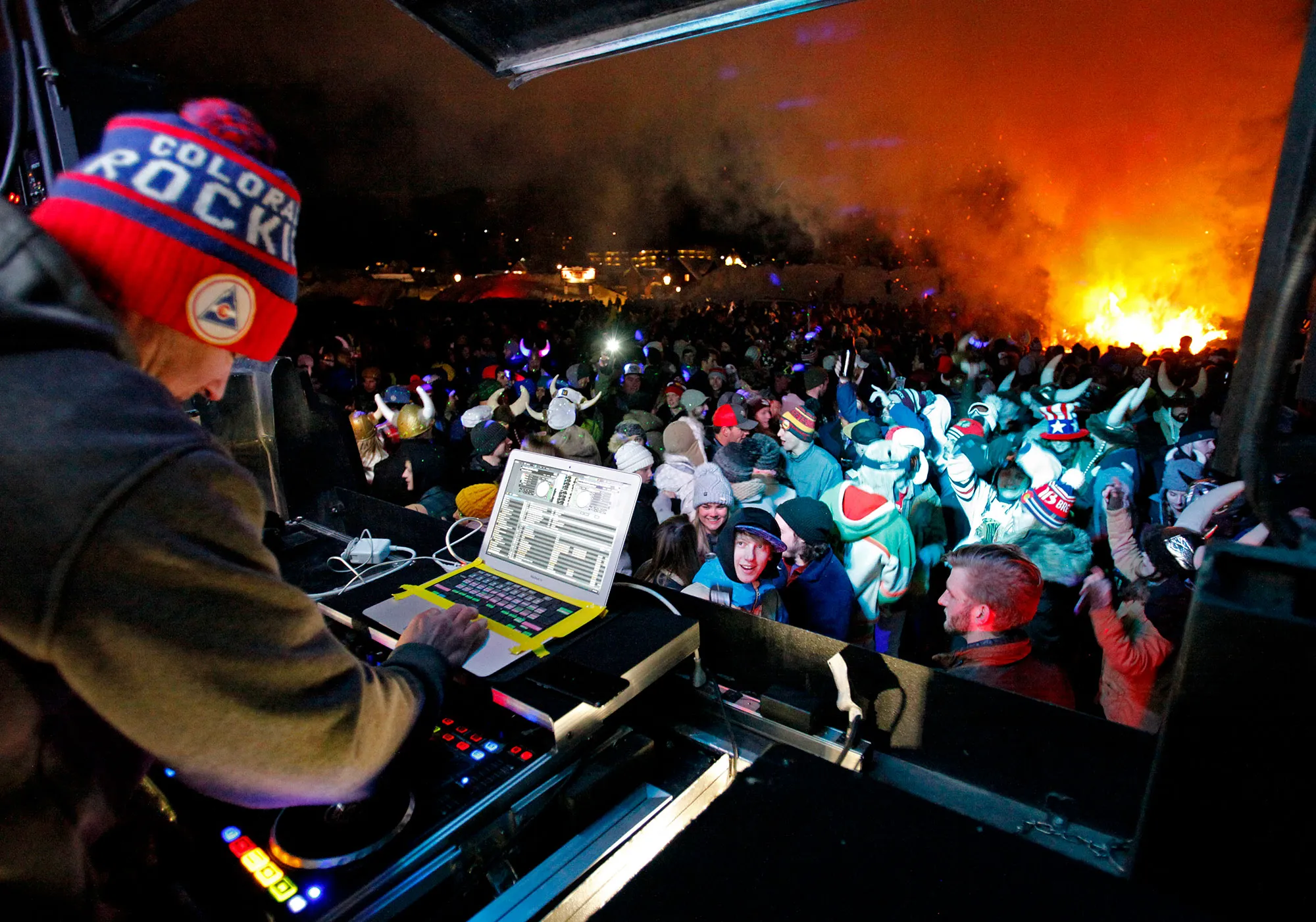 Crowd and DJ celebrating beside the Ullr Fest bonfire in Breckenridge