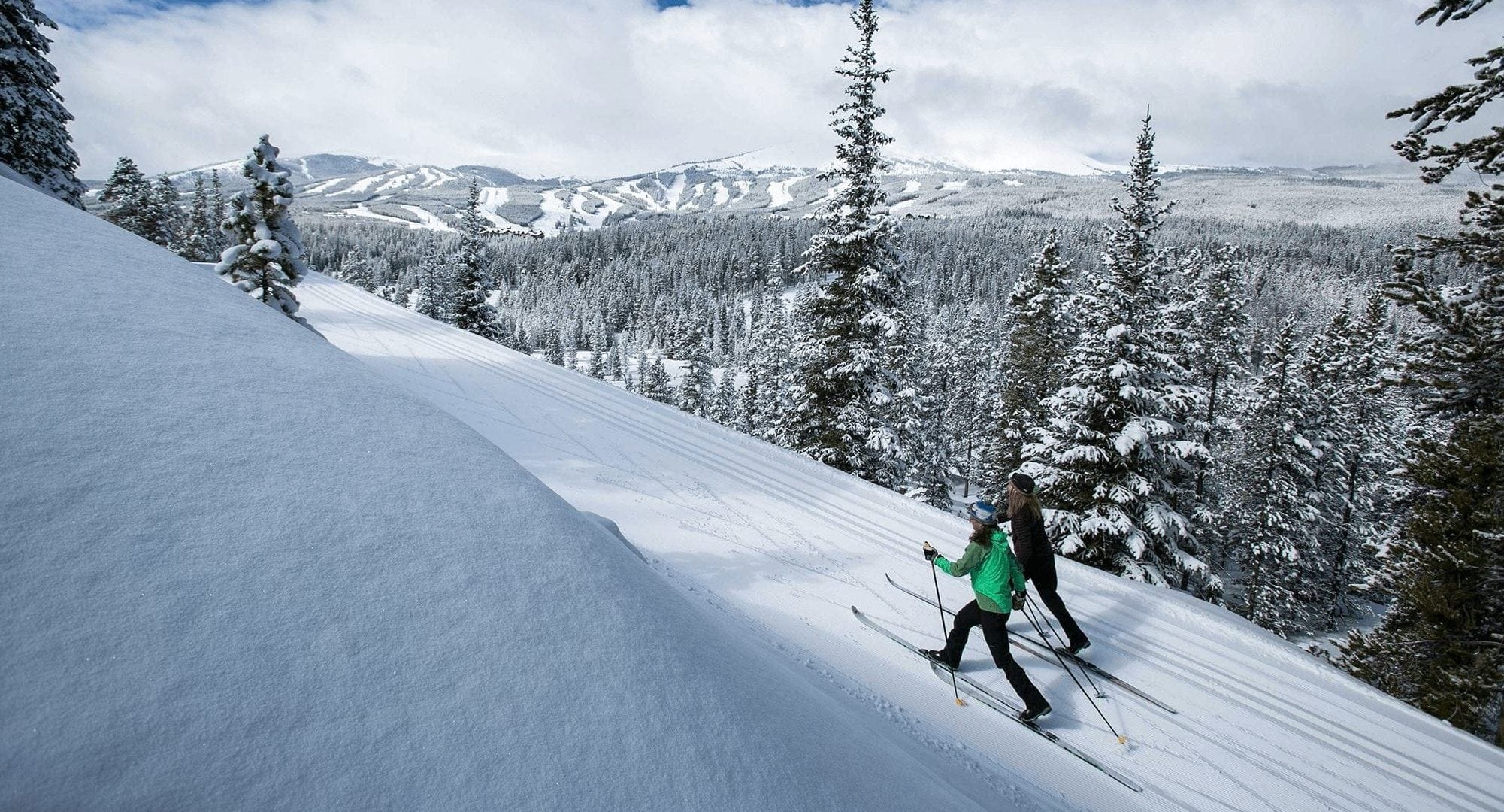 Two cross country skiers Nordic Skiing on a trail during the winter in Breckenridge, Colorado.
