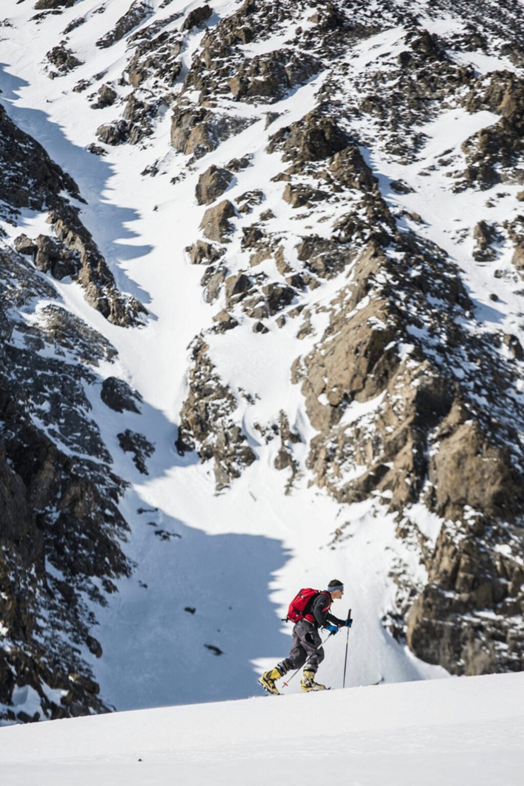 Man trekking up Breckenridge mountain to ski.