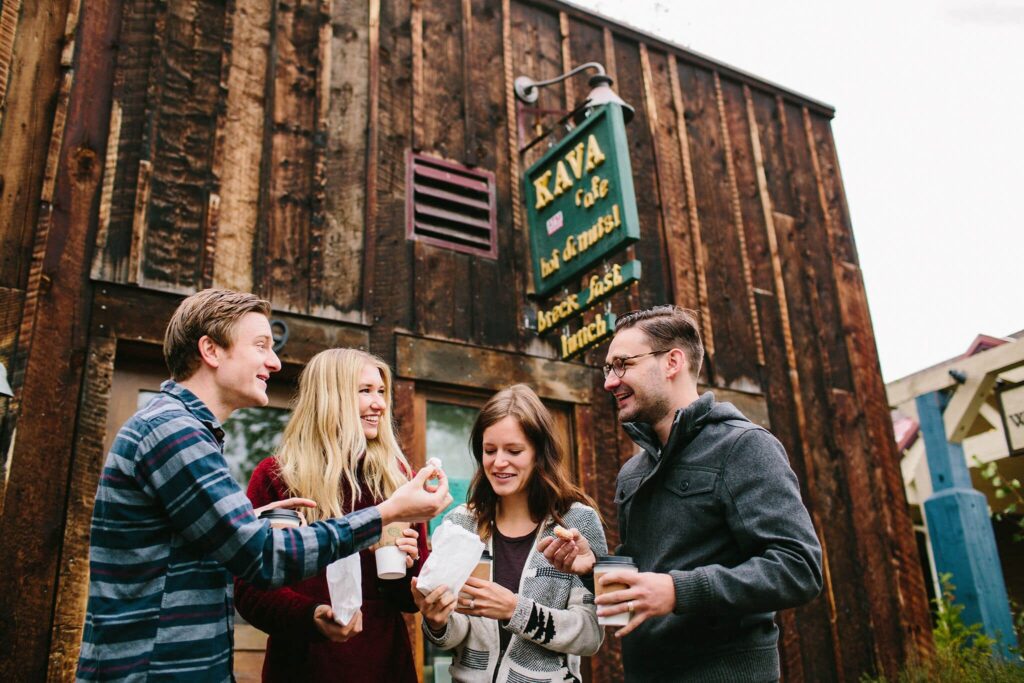 A group of friends having doughnuts on Main Street in Breckenridge.