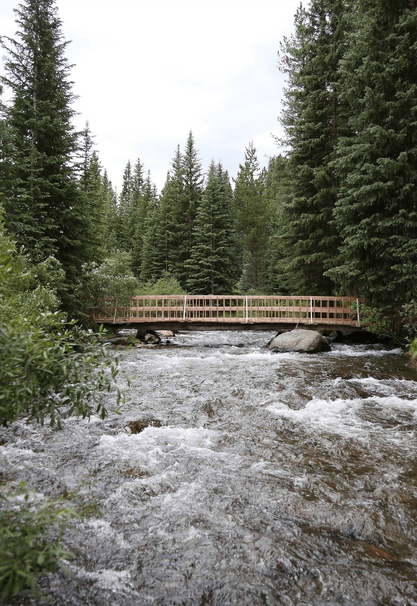 A wooden bridge spanning a river in Breckenridge