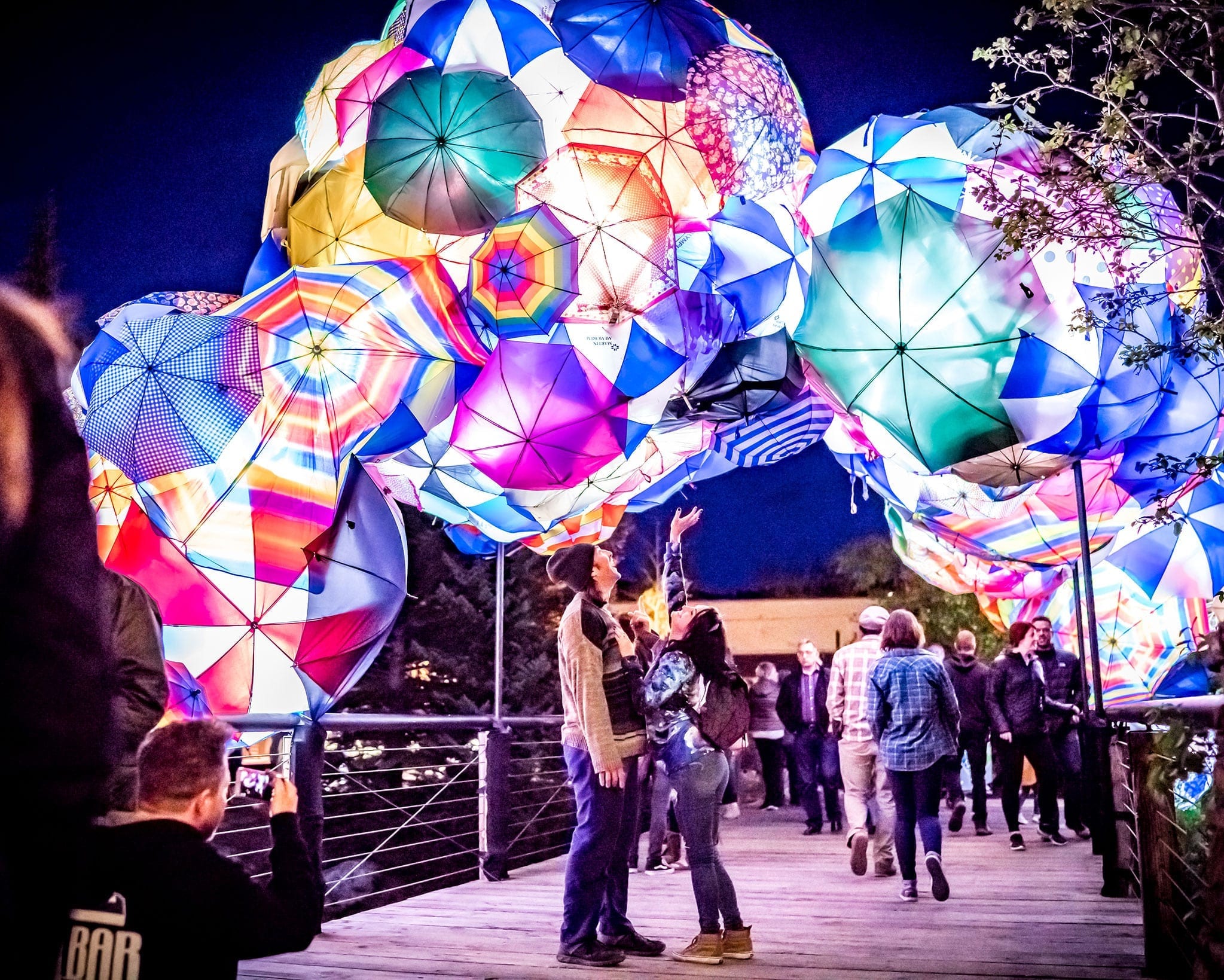 Two people under an art installation at WAVE.