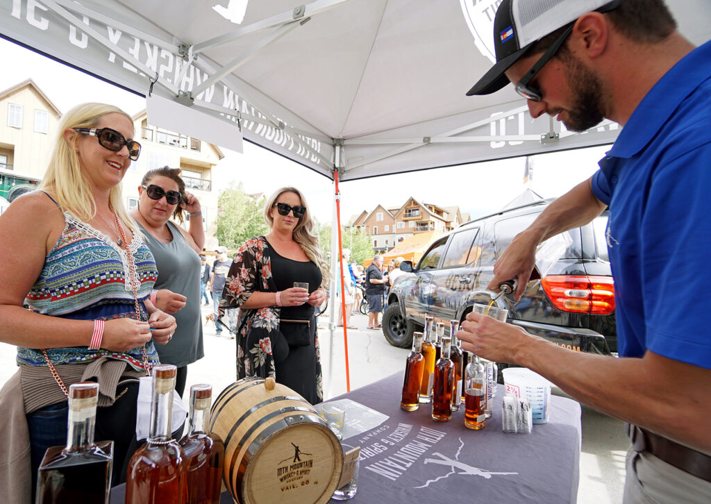 man pouring a drink for a customer