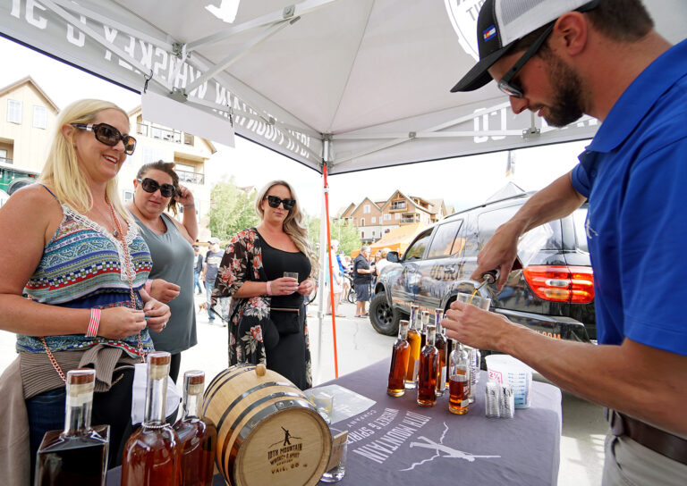 man pouring a drink for a customer