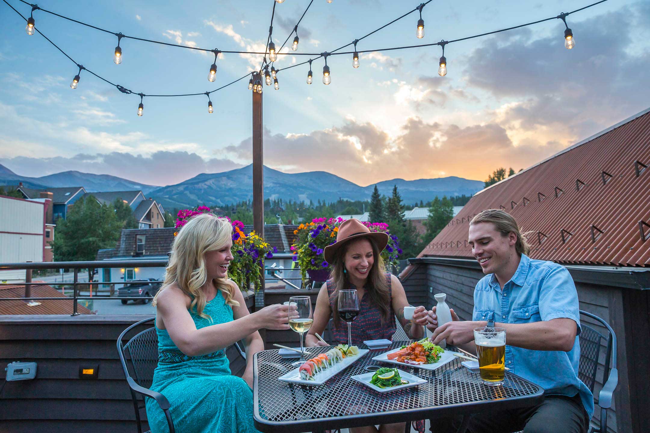 cheers group dinner sunset on Bangkok Happy Bowl patio in Breckenridge