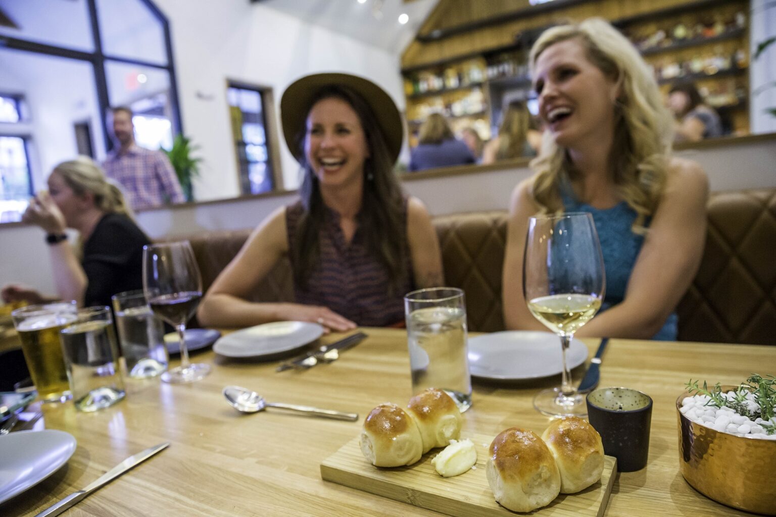 women enjoying a meal out with wine