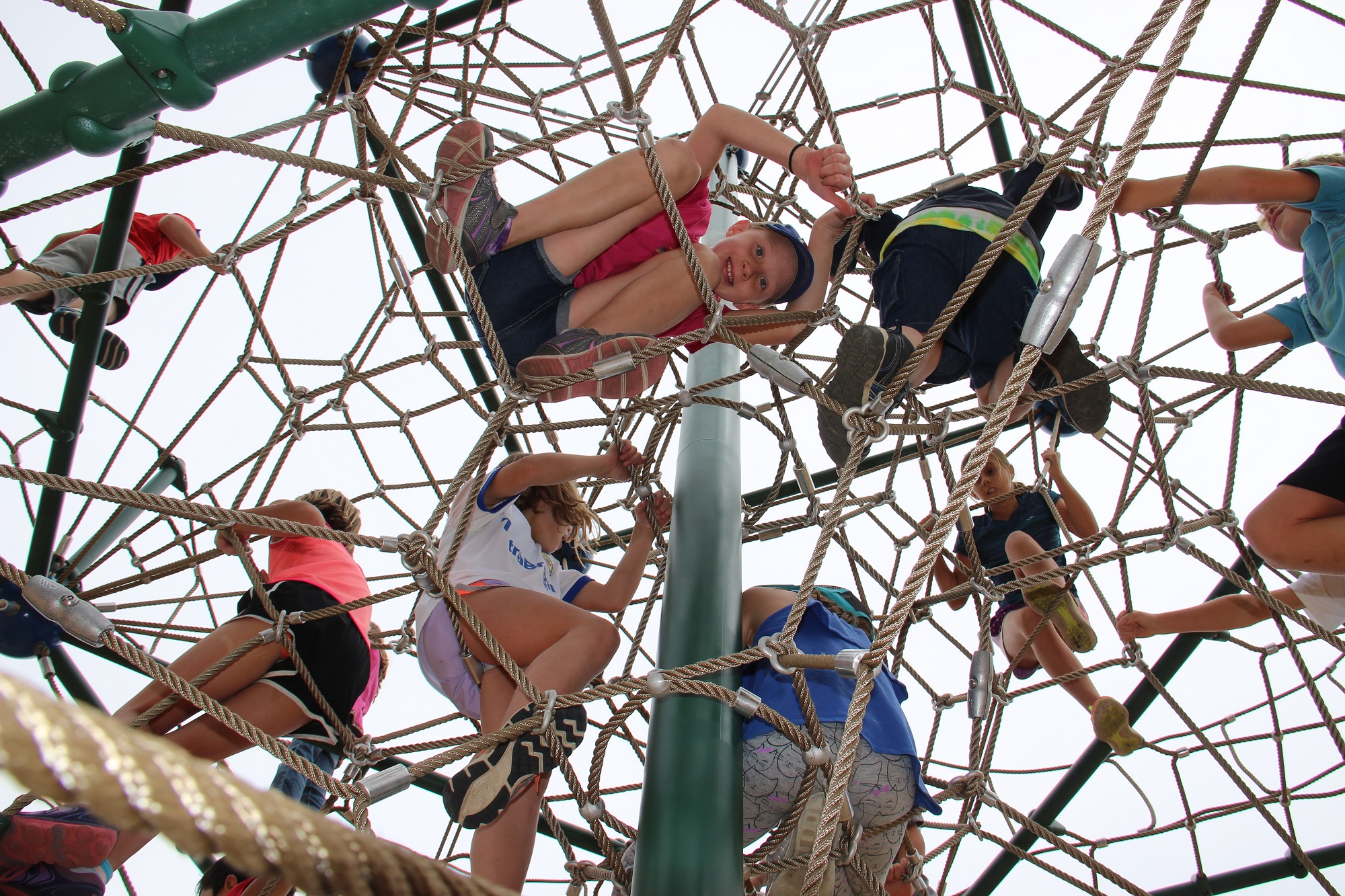 Kids playing on the ropes at Kingdom Park Playground at the Breckenridge Rec Center.