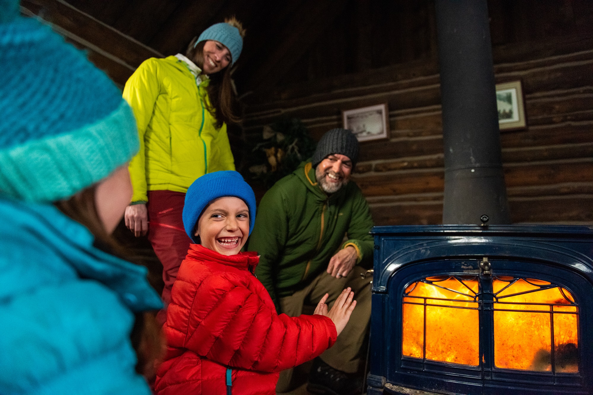 Family warming hands by a fire