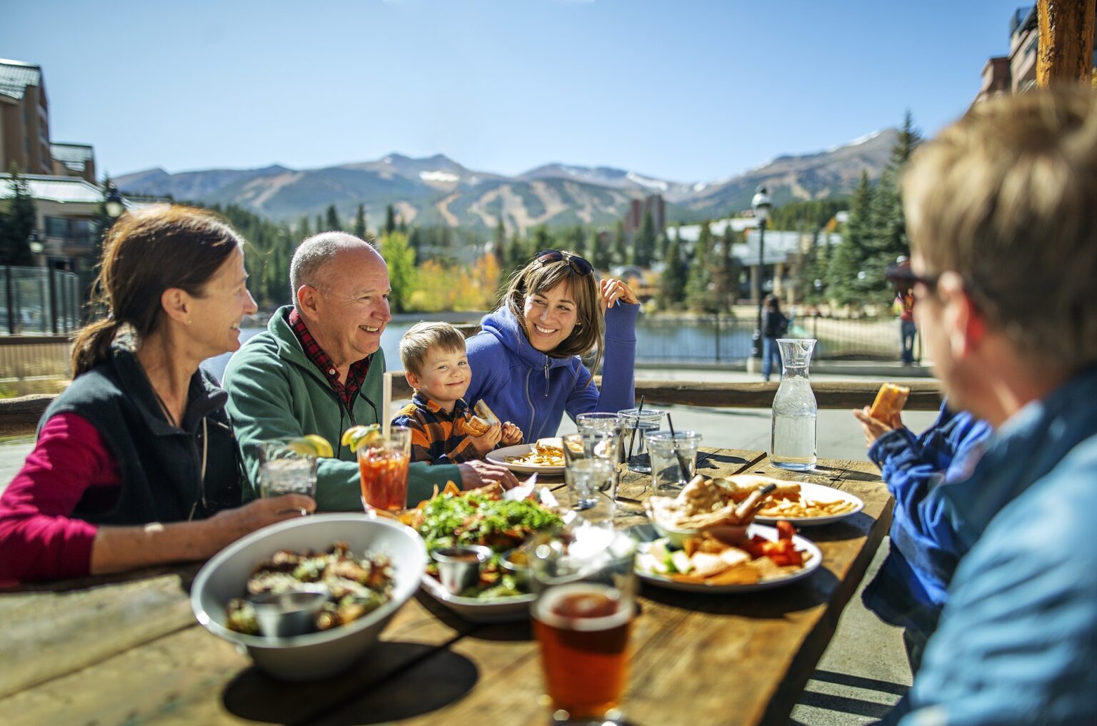 family enjoying a meal at a picnic table
