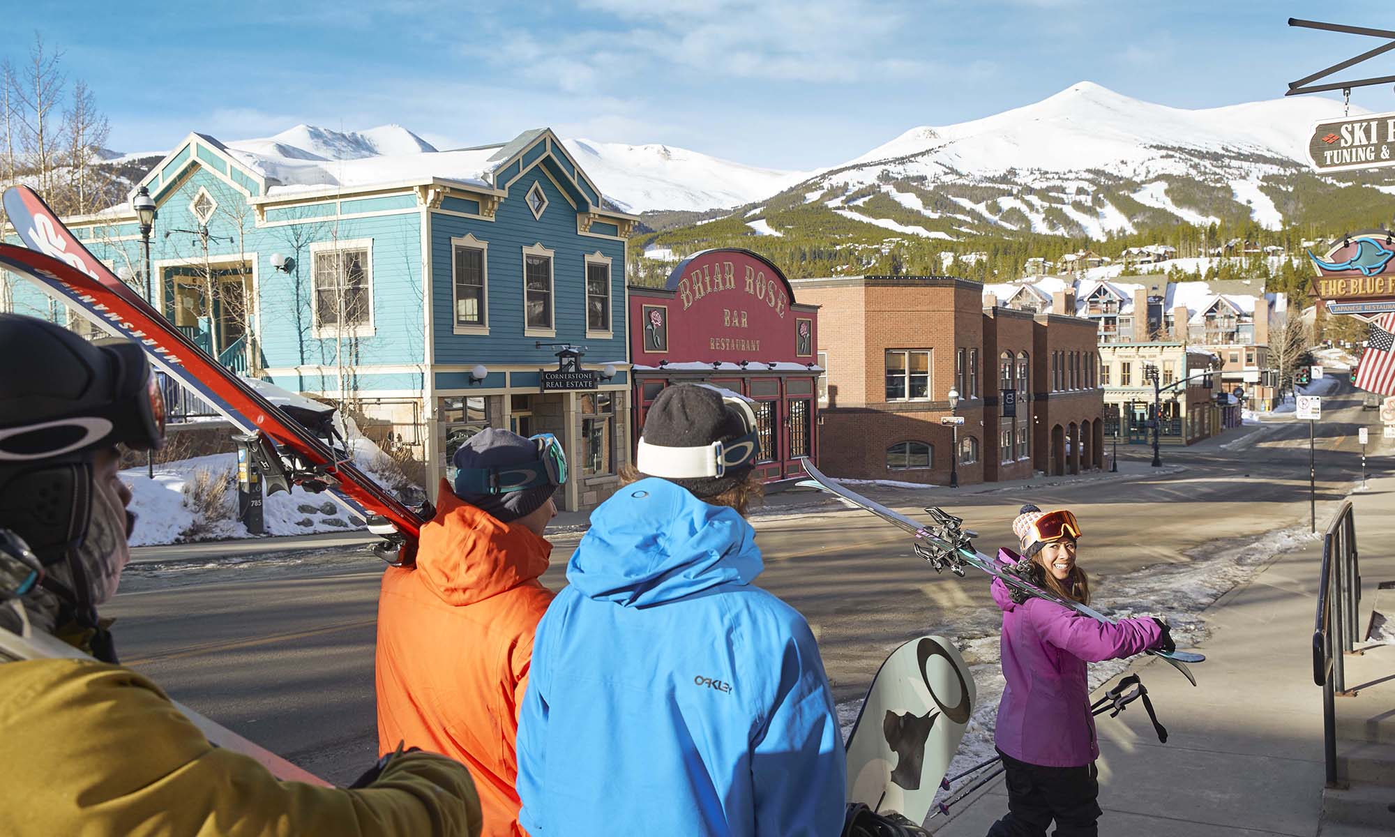 Skiers and snowboarders walking through downtown Breckenridge.