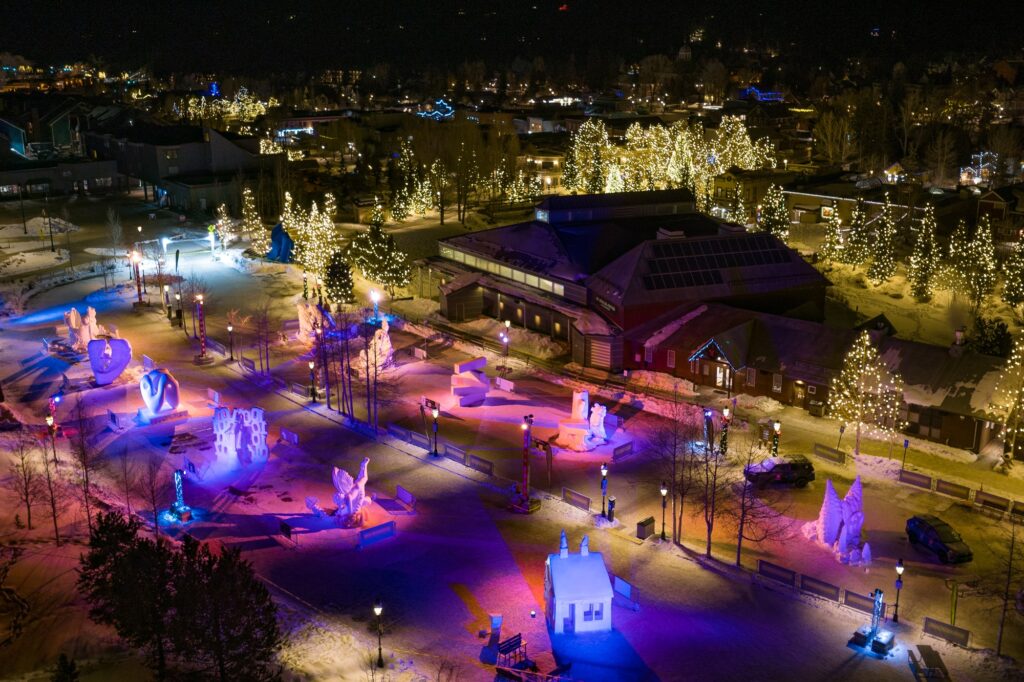 lit up snow sculptures at night