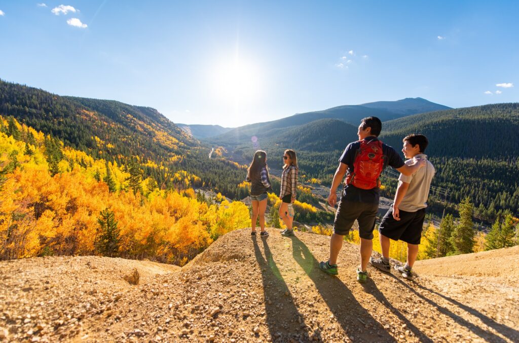 family enjoying a mountain view on a hike