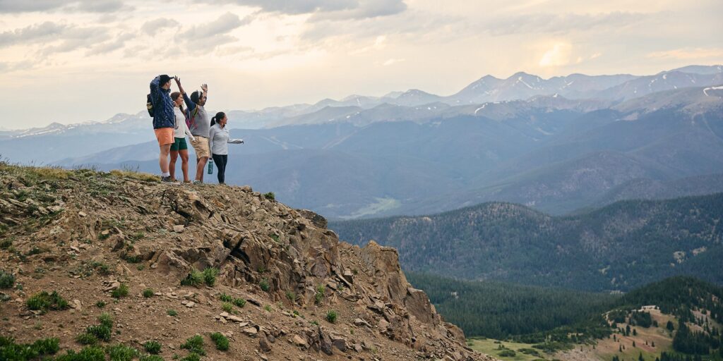 group of 4 enjoy a mountain view