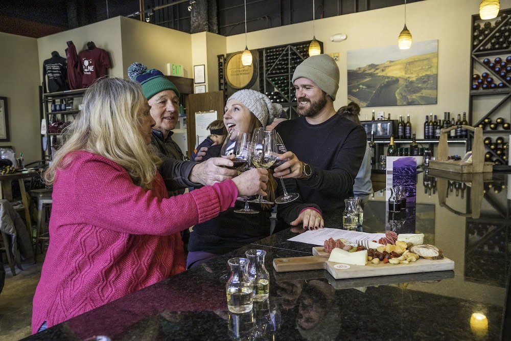 family toasting over some food at a restaurant