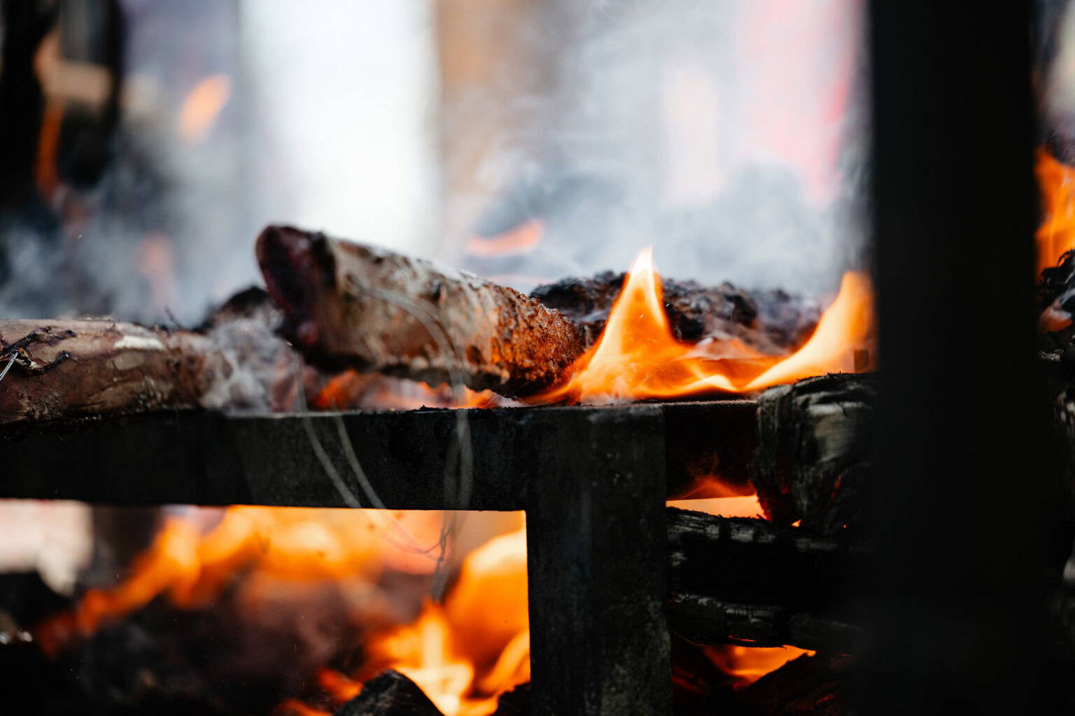 Close-up of a wood-burning fireplace with glowing flames and burning logs, creating a warm and inviting atmosphere in Breckenridge, Colorado.